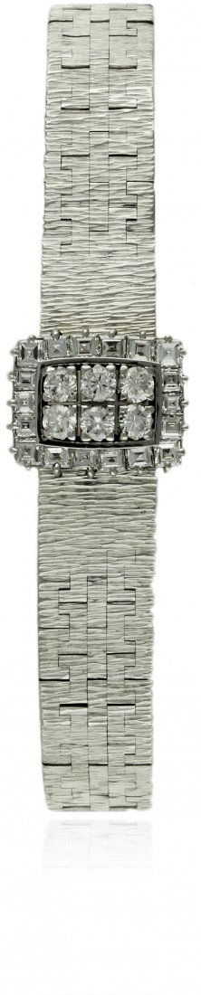 A FINE & RARE LADIES 18K SOLID WHITE GOLD DIAMOND: A FINE & RARE LADIES 18K SOLID WHITE GOLD DIAMOND PIAGET BRACELET WATCH CIRCA 1970s, REF. 1313 A 6 D: Silver dial with applied hour markers. M: Manual 'back wind' movement signed Piaget. C: Rectangula
