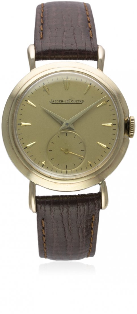 A GENTLEMAN'S 9CT SOLID GOLD JAEGER LECOULTRE WRIST: A GENTLEMAN'S 9CT SOLID GOLD JAEGER LECOULTRE WRIST WATCH CIRCA 1950s D: Gold colour dial with gilt ''dagger'' batons & dauphine hands, subsidiary seconds. M: Manual movement signed Jaeger-LeCoultre &