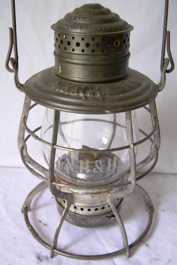 New Haven Railroad "Adams" Lantern: A New York New Haven & Hartford Railroad lantern made by Adams & Westlake. It has a beehove top and it has a correct extended base globe and twist off base. The NYNH&H etched globe goes right through 