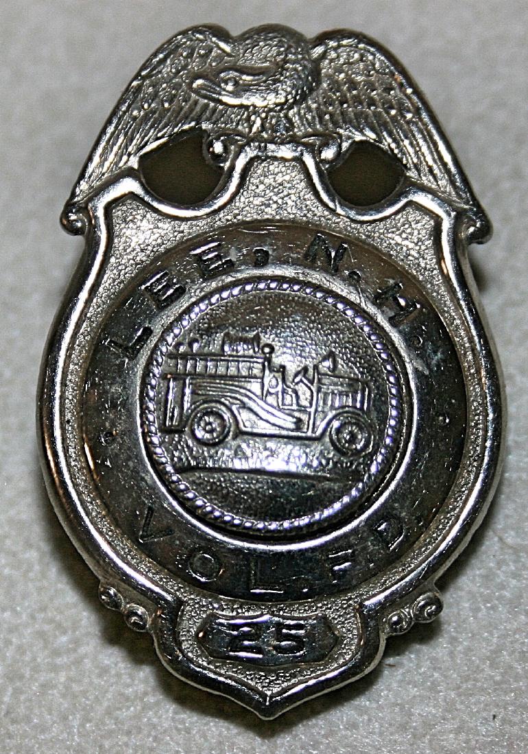 Badge: Lee NH Vol. F.D. 25: silver colored, 1 5/8" x 1 1/8"