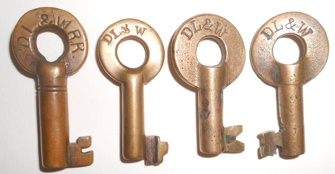 4 Lackawanna Brass Switch Style Keys: 4 brass switch style keys from the Delaware Lackawanna & Western Railroad: (1) T2382 (double ring) (2) Bohannan on reverse (3) Fraim I (4) Fraim dog-bone hallmark