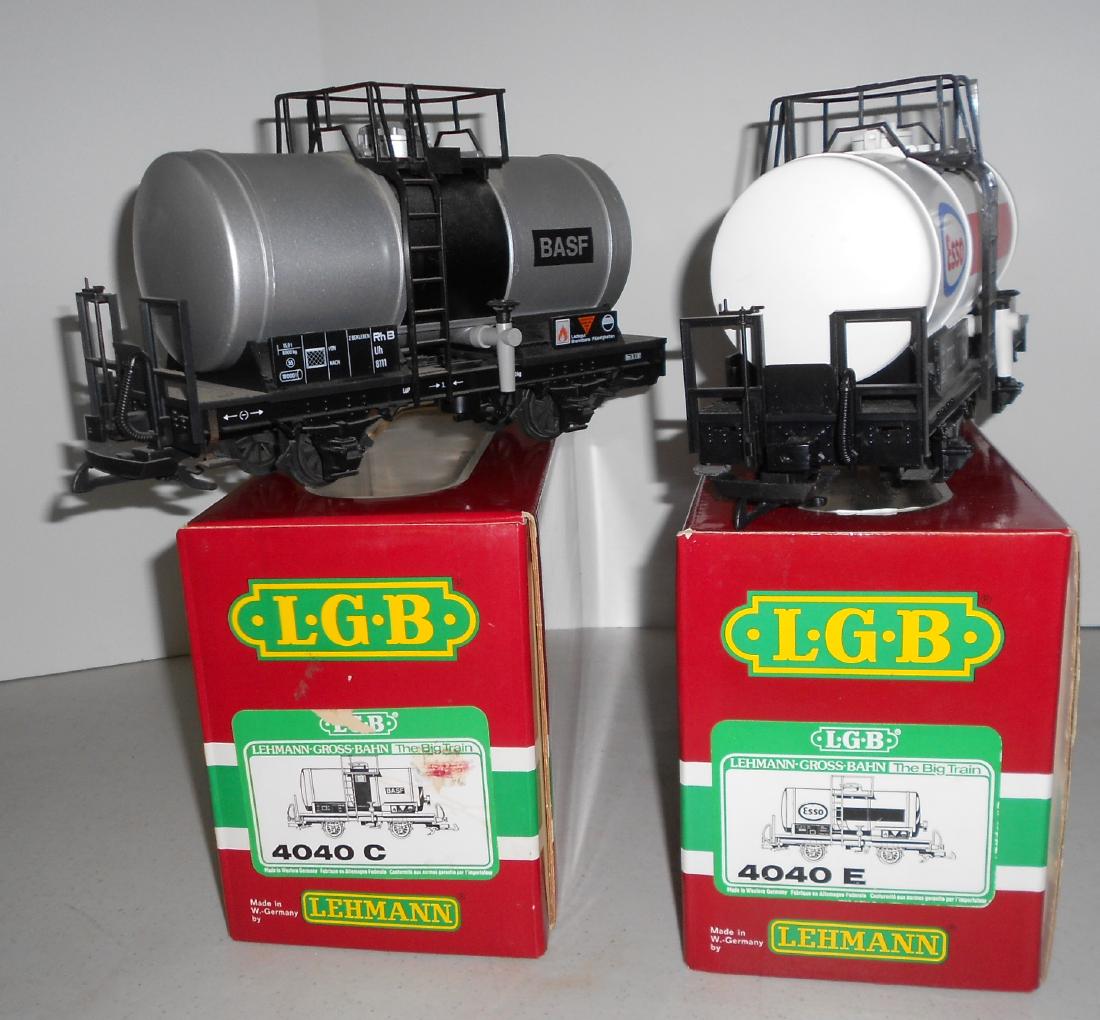 G Scale LGB Tank Cars: 4040c = BASF, 4040e = ESSO: G scale LGB tank cars. Single dome 4 wheels. Cardstock interior protectors not shown but are included. Both with plastic latch couplers: (1) 4040c BASF (2) 4040e ESSO. Both have been used on garden ra