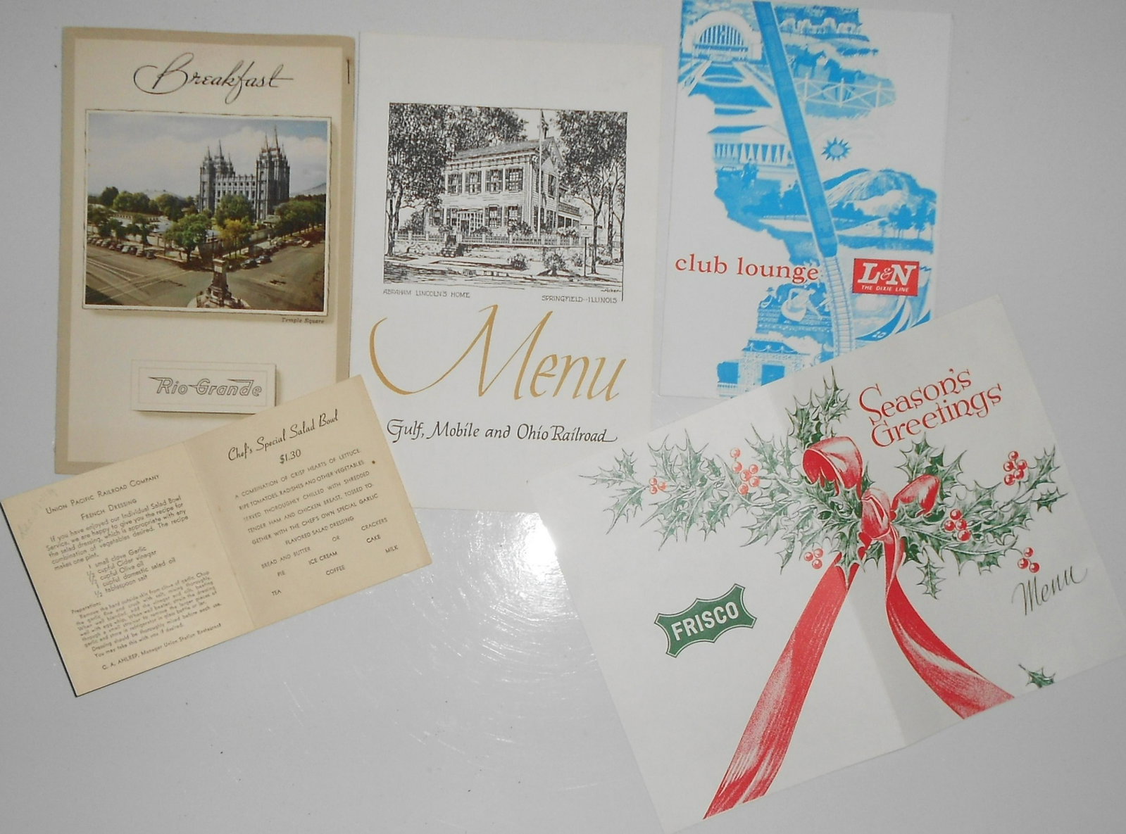 Railroad Menus (5) D&RG, L&N, GM&O, Frisco: A group of 5 dining car menus from different railroads: Rio Grande, Louisville & Nashville, Gulf Mobile & Ohio, Frisco, Southern Pacific. Age and condition vary. There are more menus in the this aucti