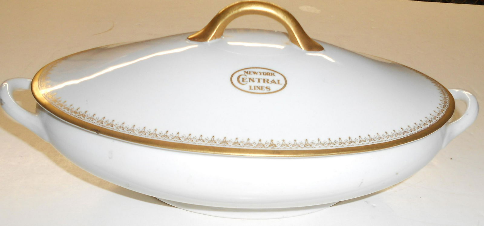 NYC Lines China "Park Avenue" Tureen: A massive china tureen made for the New York Central Lines. There is an unfortunate crack in the lid on the back side. The gold logo, that often has wear issues, is outstanding. This is a two piece un
