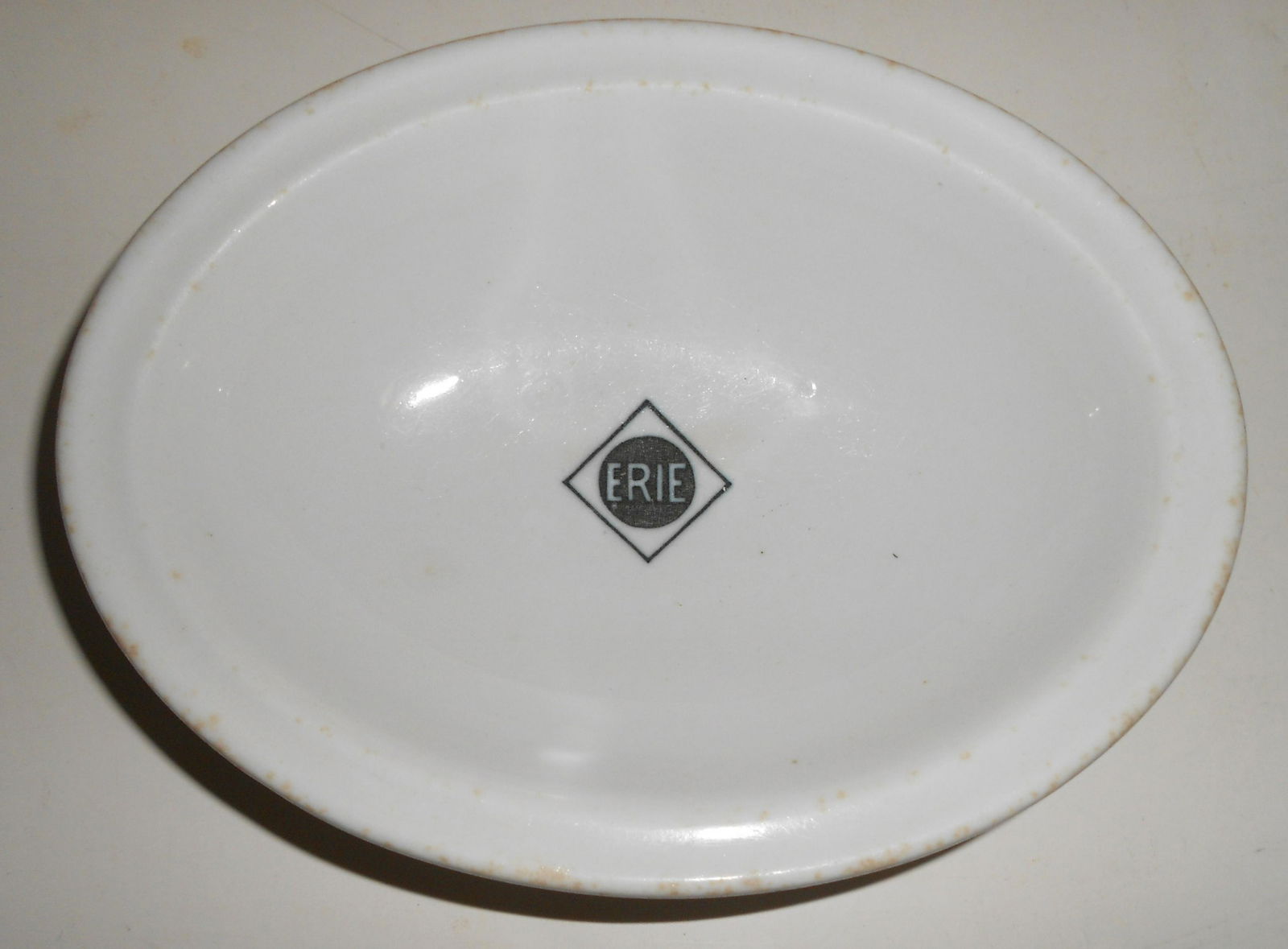 Erie Railroad "Chautauqua" pattern Dish: China oval bowl made by Greenwood Pottery for the Erie Railroad in their Chautauqua pattern. It measures 7" by 5.5" and it has a rim that flattens out. The Greenwood hallmark is recessed in the back.