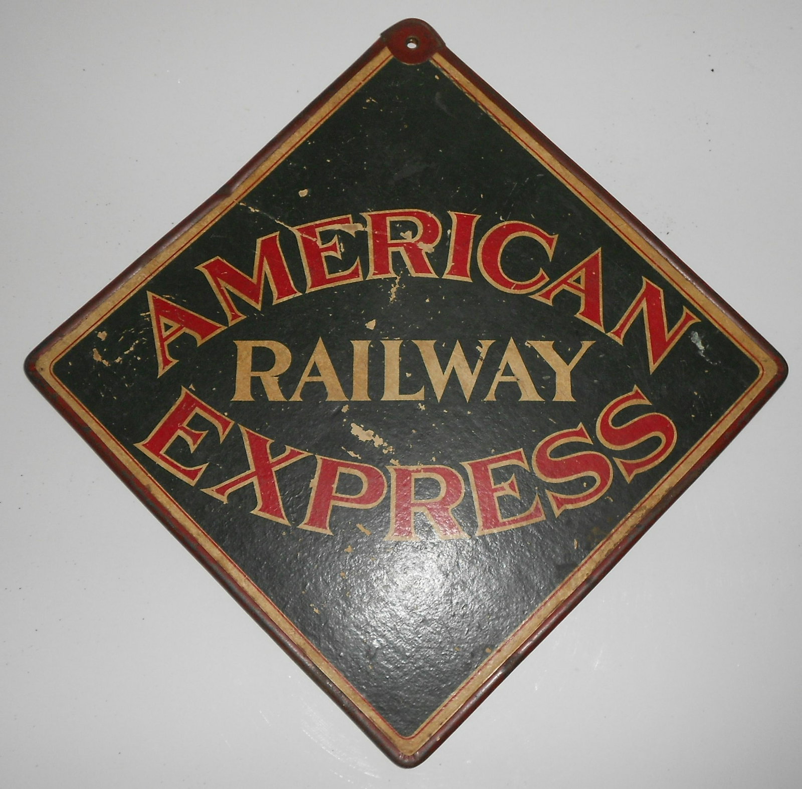 American Railway Express Call Sign: Older double sided American Railway Express "call sign" that measures 19" across and it is made of a composite compressed material with a single mounting hole at the top. This type of sign was display