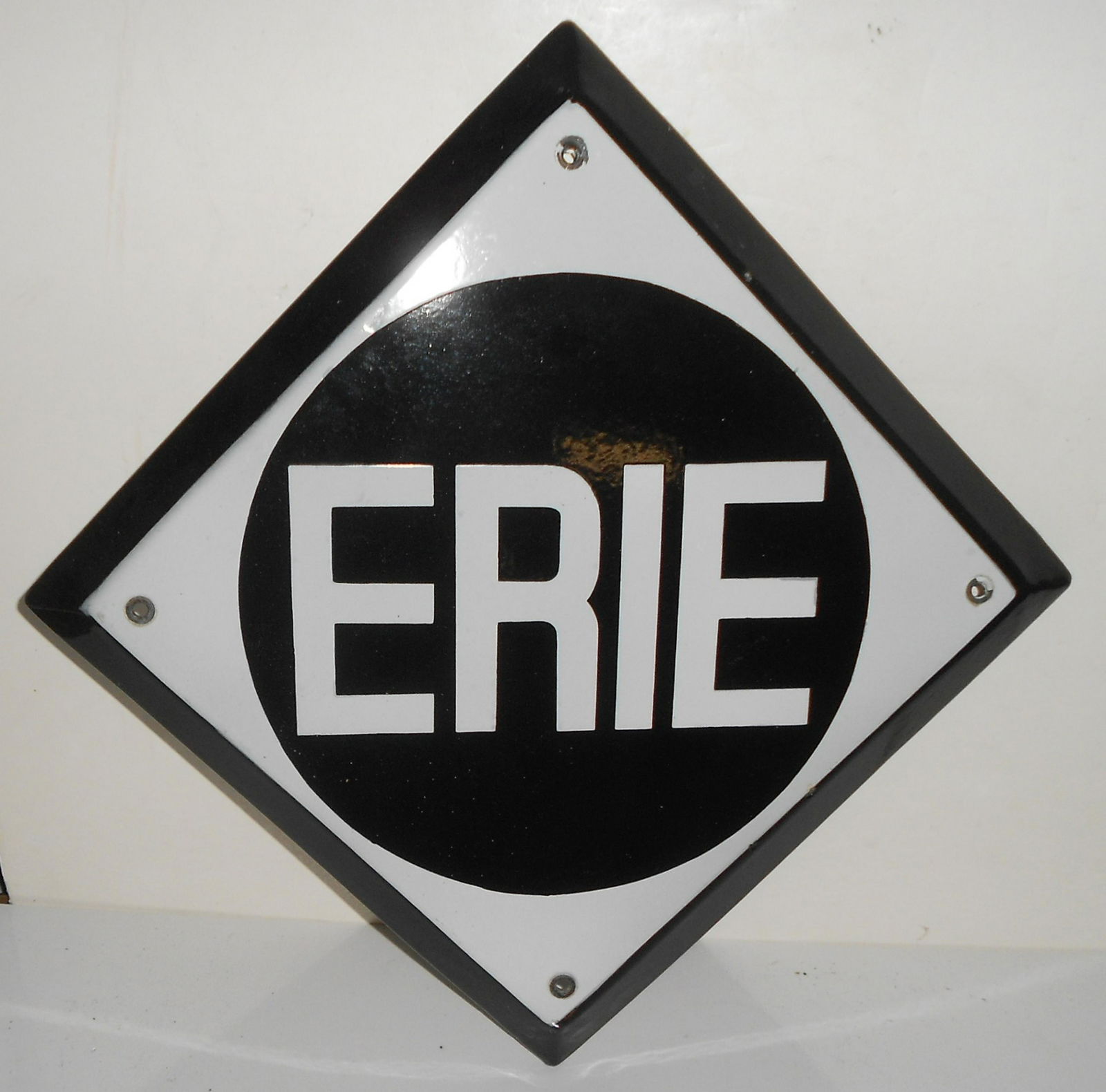 Erie Railroad Porcelain Sign Diamond Logo: A fine porcelain sign made for the Erie Railroad. The sign measures 20" across and the Erie circle in the center has a diameter of 11 1/2". This sign has a nice beveled edge. It has 4 mounting holes a