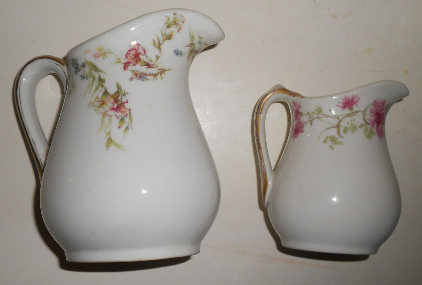 2 NYC Railroad China Pitchers: A pair of New York Central Railroad china pitchers: (1) 5" tall "Depew" pattern with nice backstamp (2) 4" tall "Hyde Park" pattern with Limoges backstamp. A nice pair of pitchers in floral patters fr