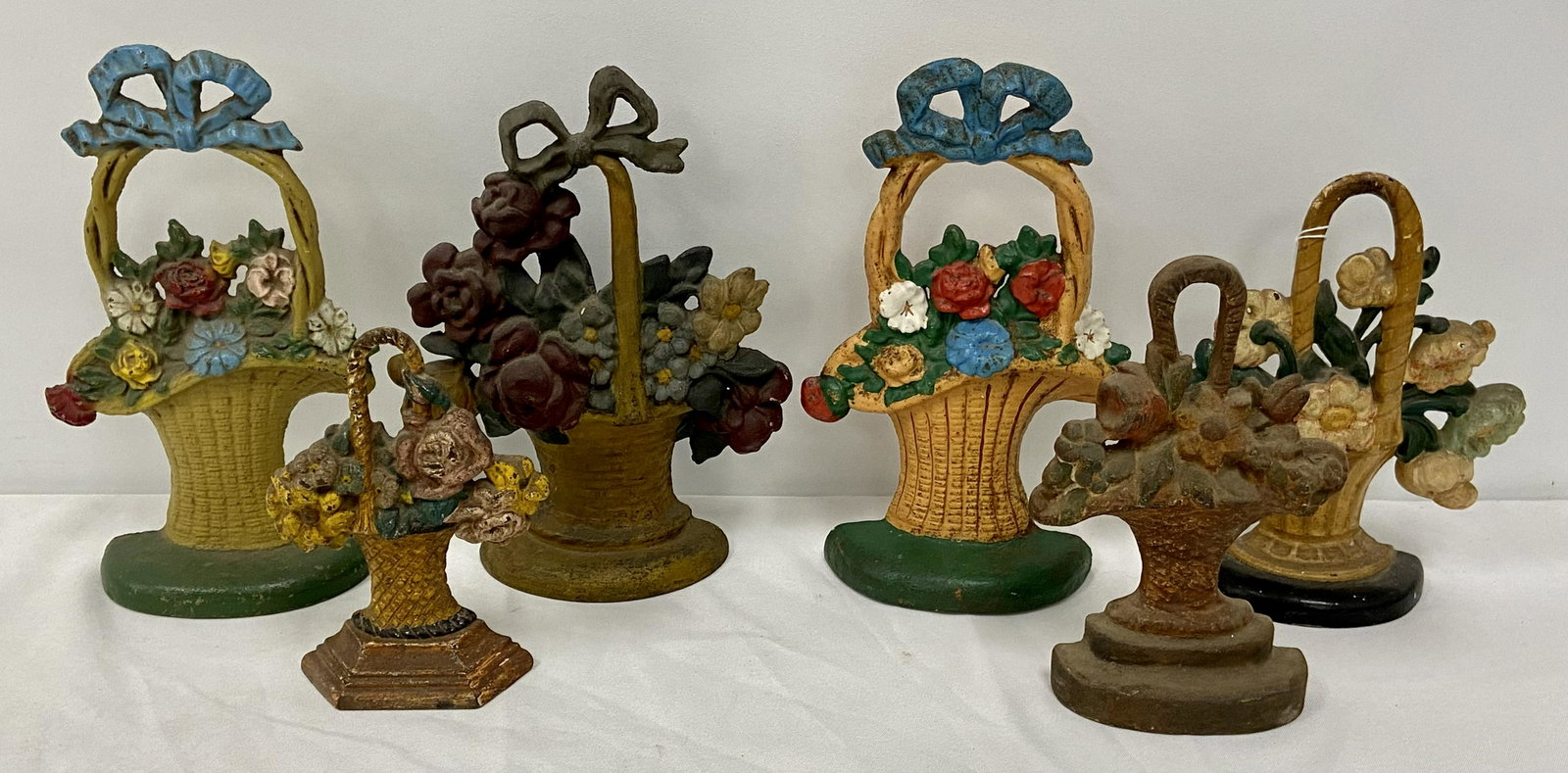 Six Floral Cast Iron Doorstop Baskets: Six Floral Cast Iron Doorstops Baskets, all in paint, normal wear & tear, see photos