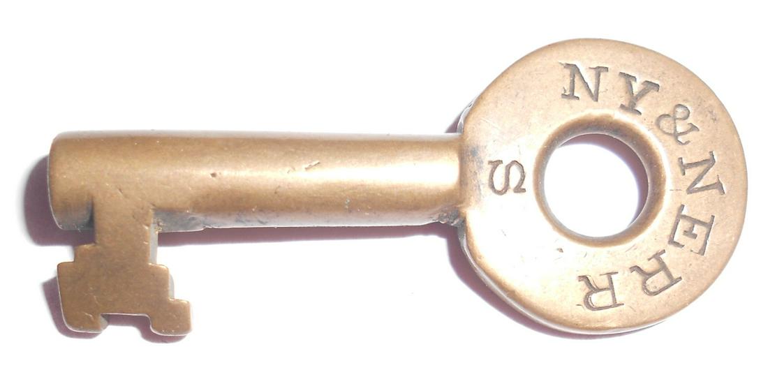 New York & New England Railroad Switch Key: An older tapered barrel key made for the New York & New England Railroad. It is stamped NY&NE RR on one side. It has their standard bit with "2 teeth". It has "2527 stamped on the reverse.