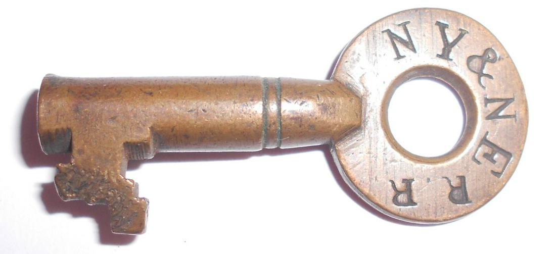 NY&NE Railroad T. Slaight Switch Key: An older tapered barrel key made for the New York & New England Railroad by Thomas Slaight. It is stamped NY&NE RR on one side with the RR being on a tangent. The reverse has the typical T. Slaight ha