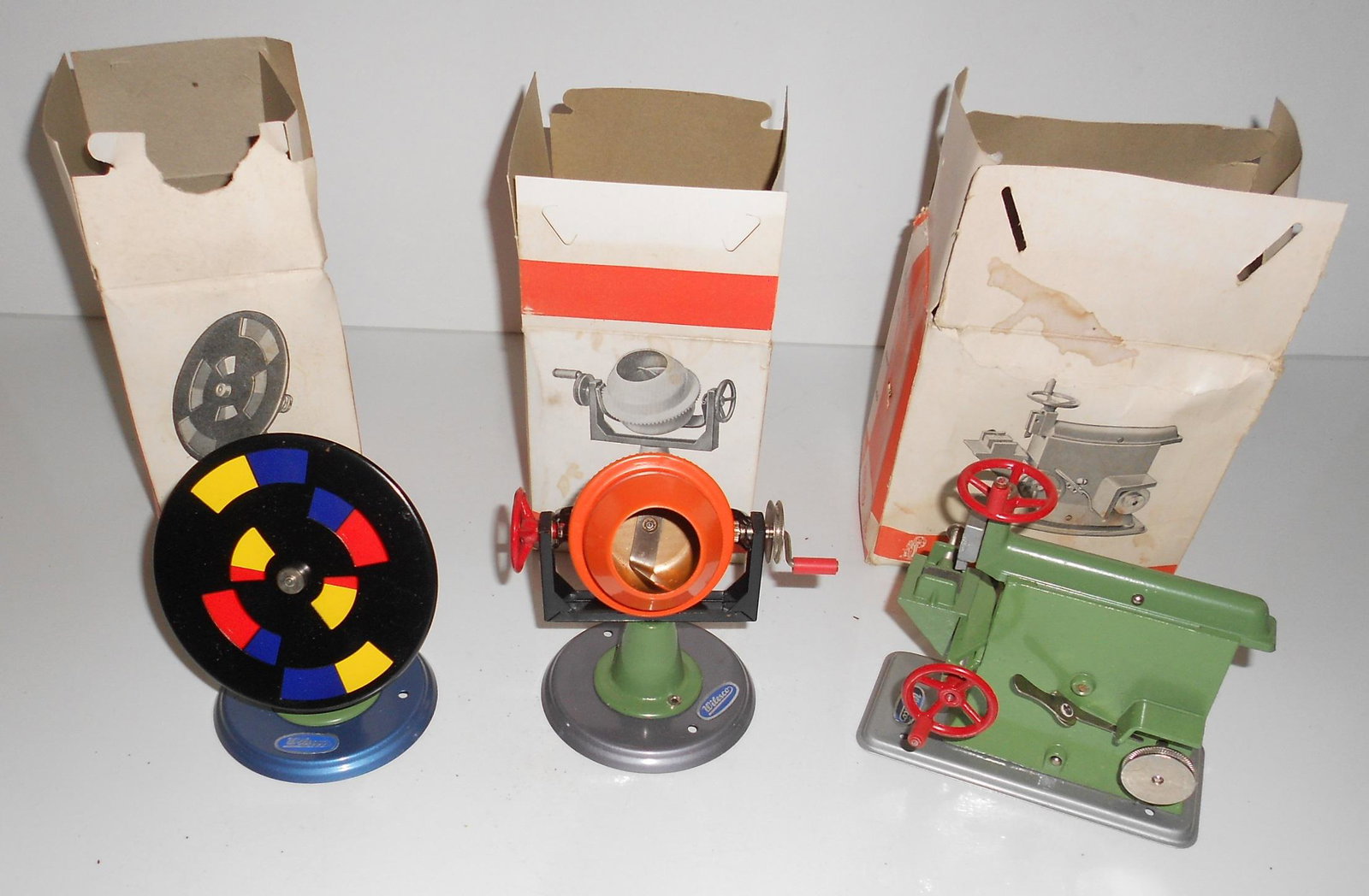Wilesco Steam Toys (3) in Boxes: M54, M63, M65: A group of 3 Wilesco steam toys in original orange boxes. The toys are in great shape. The boxes show age and some wear. All have F. A. O. Schwarz price stickers. This group consists of: (1) M54 Combi
