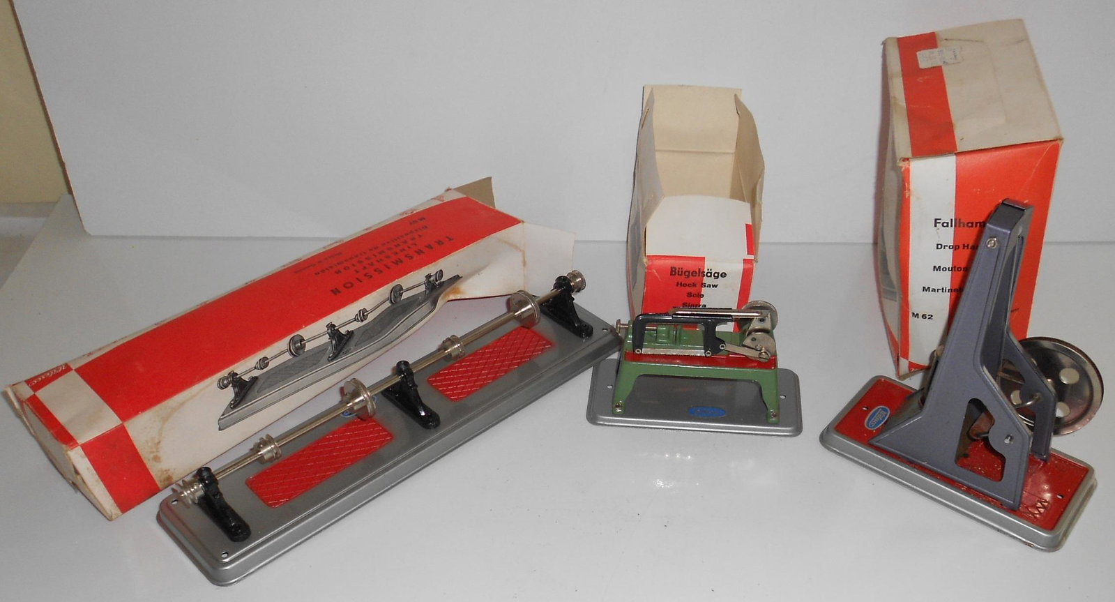 Wilesco Steam Toys (3) in Boxes: M57, M60, M62: A group of 3 Wilesco steam toys in original orange boxes. The toys are in great shape. The boxes show age and some wear. All have F. A. O. Schwarz price stickers. This group consists of: (1) M57 Trans