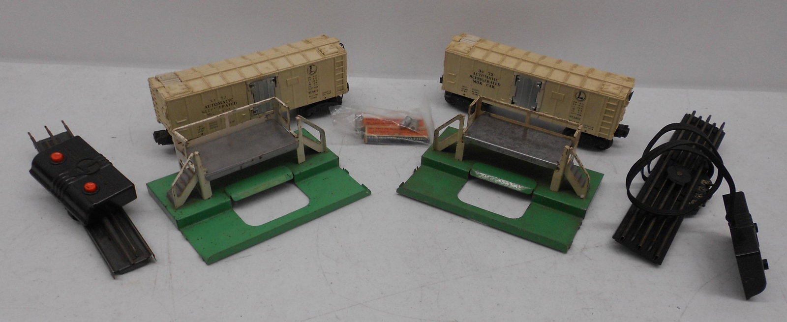 Lionel 027 Two Milk Stations with cars & Cans 3472: Lionel 027 pair of 3472 - milk stations with cars, track and some magnetic cans in packages. No boxes or instructions. Light use.