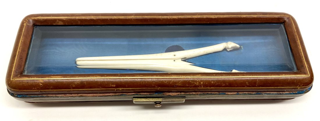 Ladies Victorian Glove Box with Stretcher: Really Nice Leather Ladies Expanding Glove Box With Original Carved Bone Glove Stretcher. Brass Hinges and Clasp Beveled Glass Top. Leather shows signs of wear. 10.5" x 3.5" x 1.5"