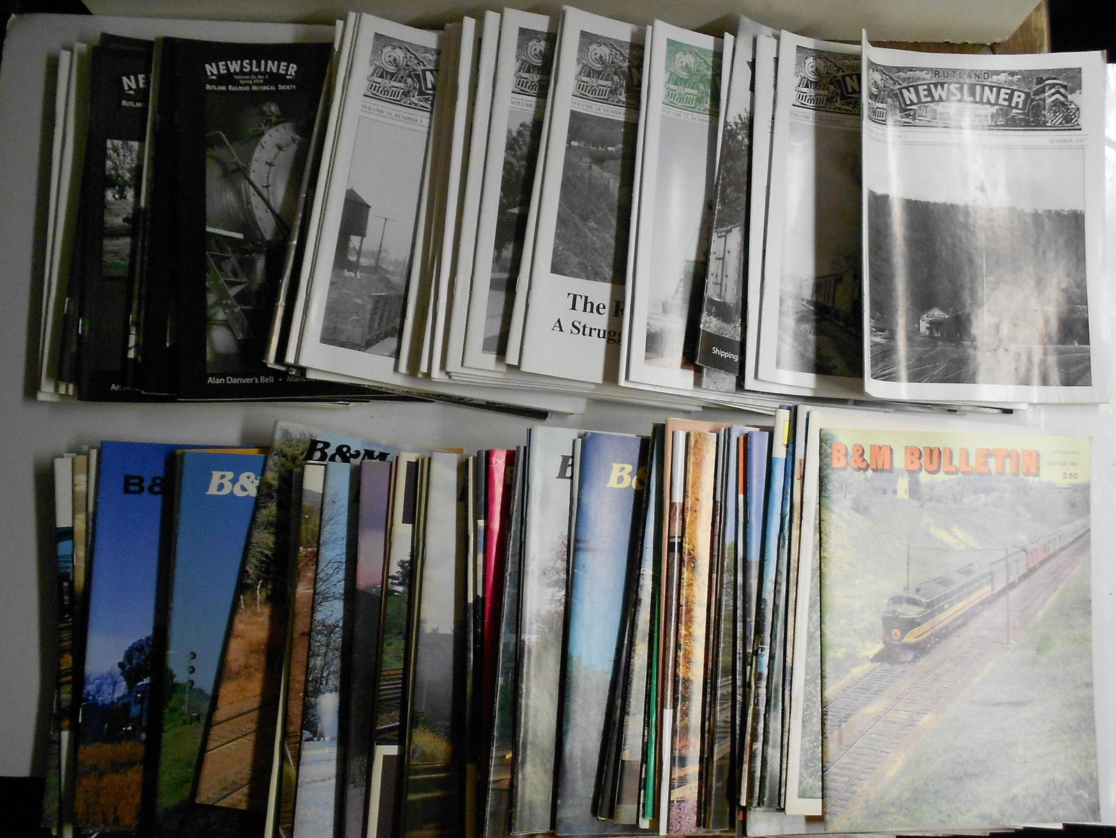 95+- B&M Bulletins & Rutland Newsliners: A large group of Rutland Railroad Historical society "Newsliner" magazines (43+-) and Boston & Maine Railroad Historical Society "B&M Bulletins" (52+-). Some have a bit of fold on the bindings.