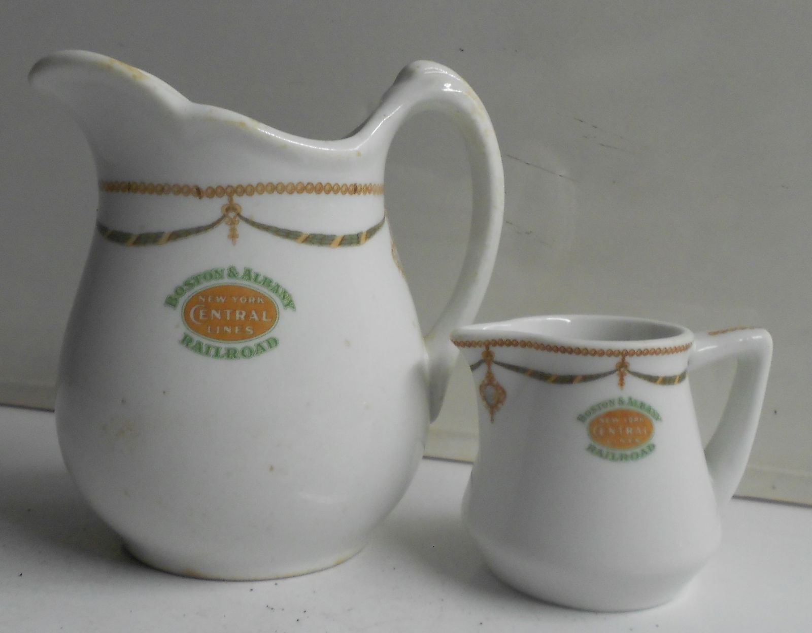 Boston & Albany Railroad - 2 China Creamers "Berkshire" pattern: A pair of china handled creamers made for the Boston & Albany Railroad in their "Berkshire" pattern. One is an individual size with no markings on the bottom. The larger more bulbous version has the s