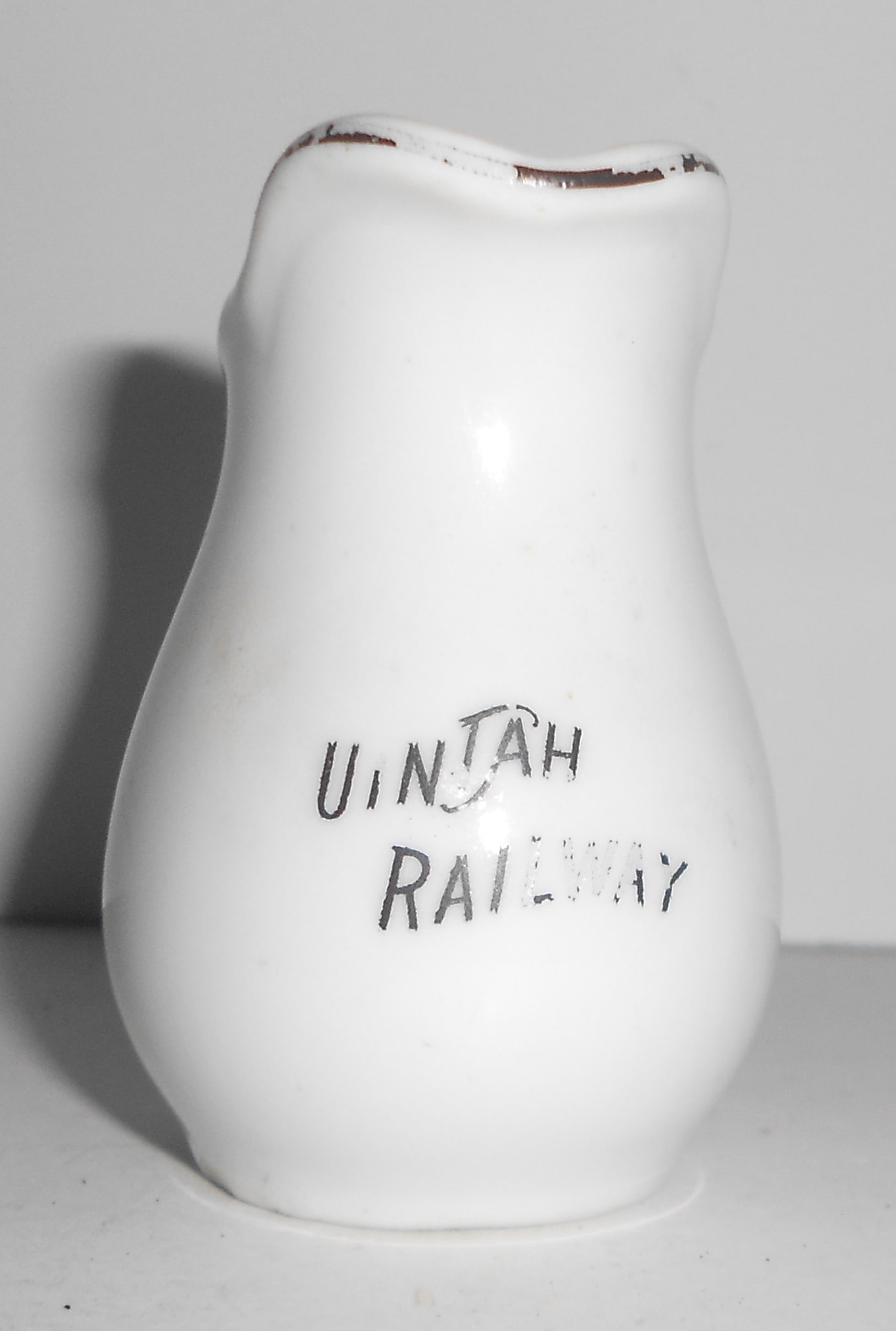 Uintah Railway China - Individual Handled Creamer: A very small, handled, china creamer made for the Uintah Railway. The Uintah was a Western narrow gauge line that did not have a dining car but they did operate dining rooms at some locations. This pi