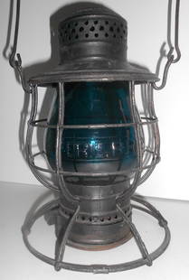 Erie Railroad Lantern by Ham,  Green Cast E/B ERIE RR CO globe: C. T. Ham wire bottom railroad lantern with wide base plate. The frame was painted flat black at some point. It has ERIE RR boldly stamped on the lid with Ham #39 marking on the very top. The kicker i