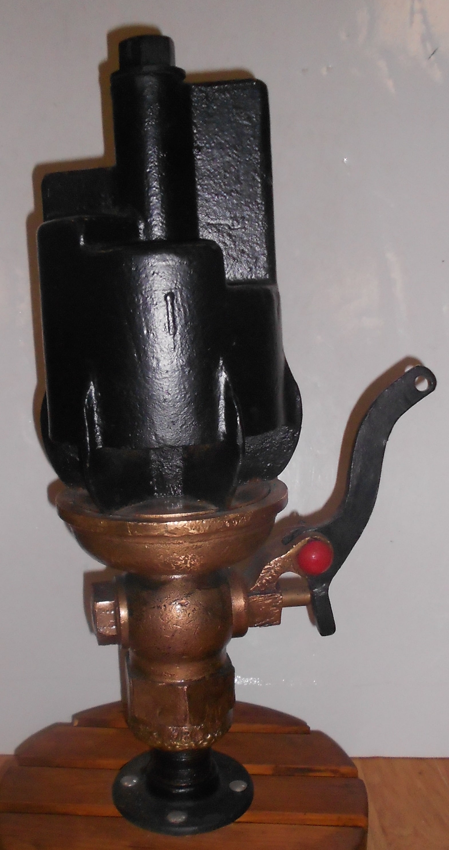 Santa Fe Steam Locomotive 5 Step / Chime Whistle: A brass 5 step Nathan style whistle with AT&SF cast into the top. A beast that is mounted on a rolling wooden base. This is not a common item. Black paint on most of it. A dent in the base plate on on