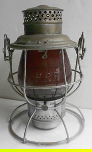 Pennsylvania Railroad Adlake Reliable Lantern - Fine Cast E/B Flashed Red Globe: An Adlake Reliable model with the Pennsylvania Railroad Keystone logo stamped in the very top. There is some light rust on the frame. The kicker is the Red Cast PRR globe. The globe is flashed red (th