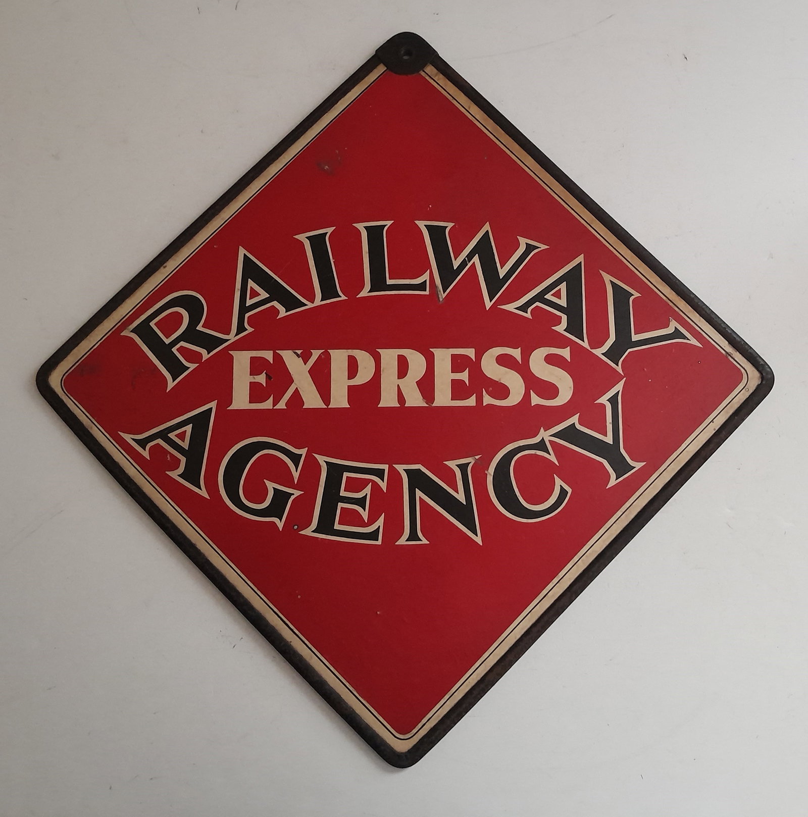 Railway Express Agency Composite "Call" Sign 19": A composite sign with border and heavier reinforced hanging hole at the top. Double sided with Railway Express Agancy spelled out across the center. Standard Red, White & Black lettering. I measure "d