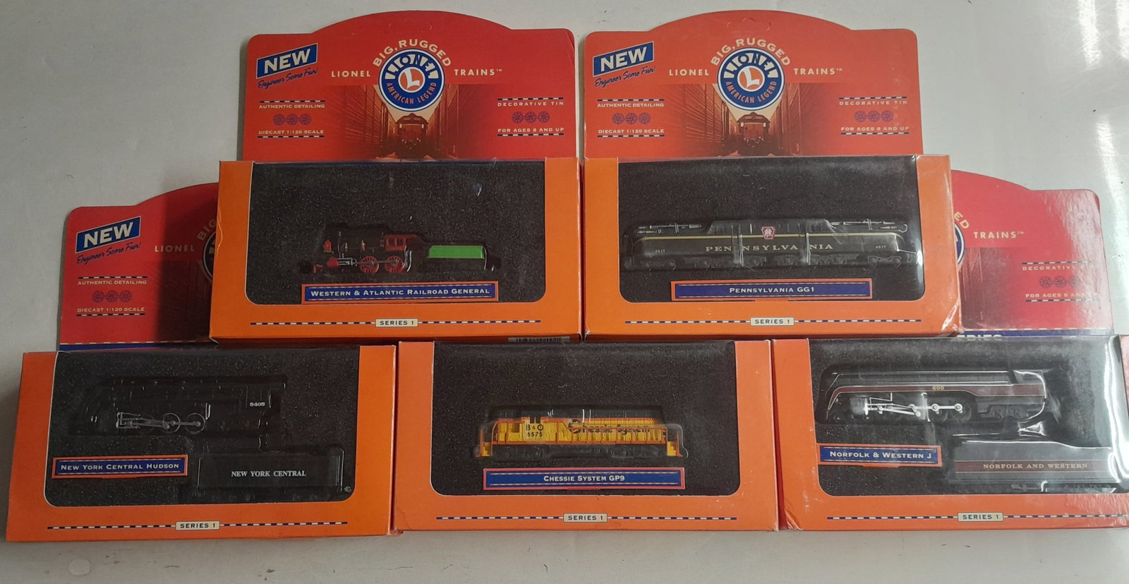 5 Lionel 1:200 scale locomotives: 5 new in the box Lionel 1:200 scale locomotives from Series #1, N&W "J", New York Central Hudson, Pennsy GG1, 2 others. Boxes show a little rubbing.