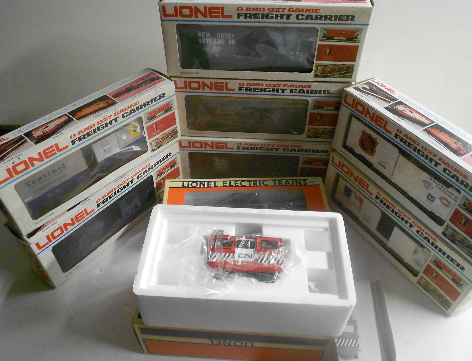 Lionel O Gauge Boxed Freight Cars (9) CN Speeder: Lionel boxed freight cars. Various age and types. An unused Canadian National Speeder with instructions. Some show signs of wear to plastic windows from storage.
