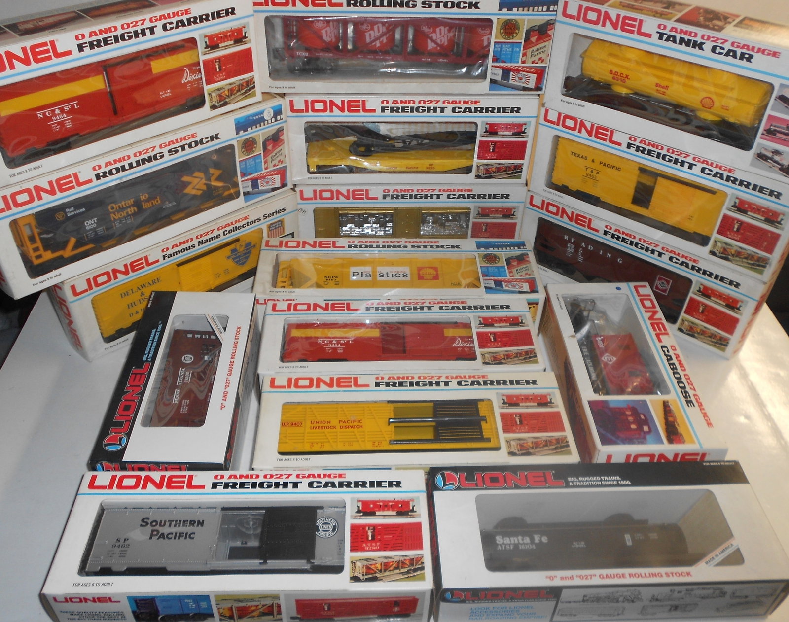 Lionel O Gauge Boxed Freight Cars (16): Lionel boxed freight cars. Various age and types. Some show signs of wear to plastic windows from storage.