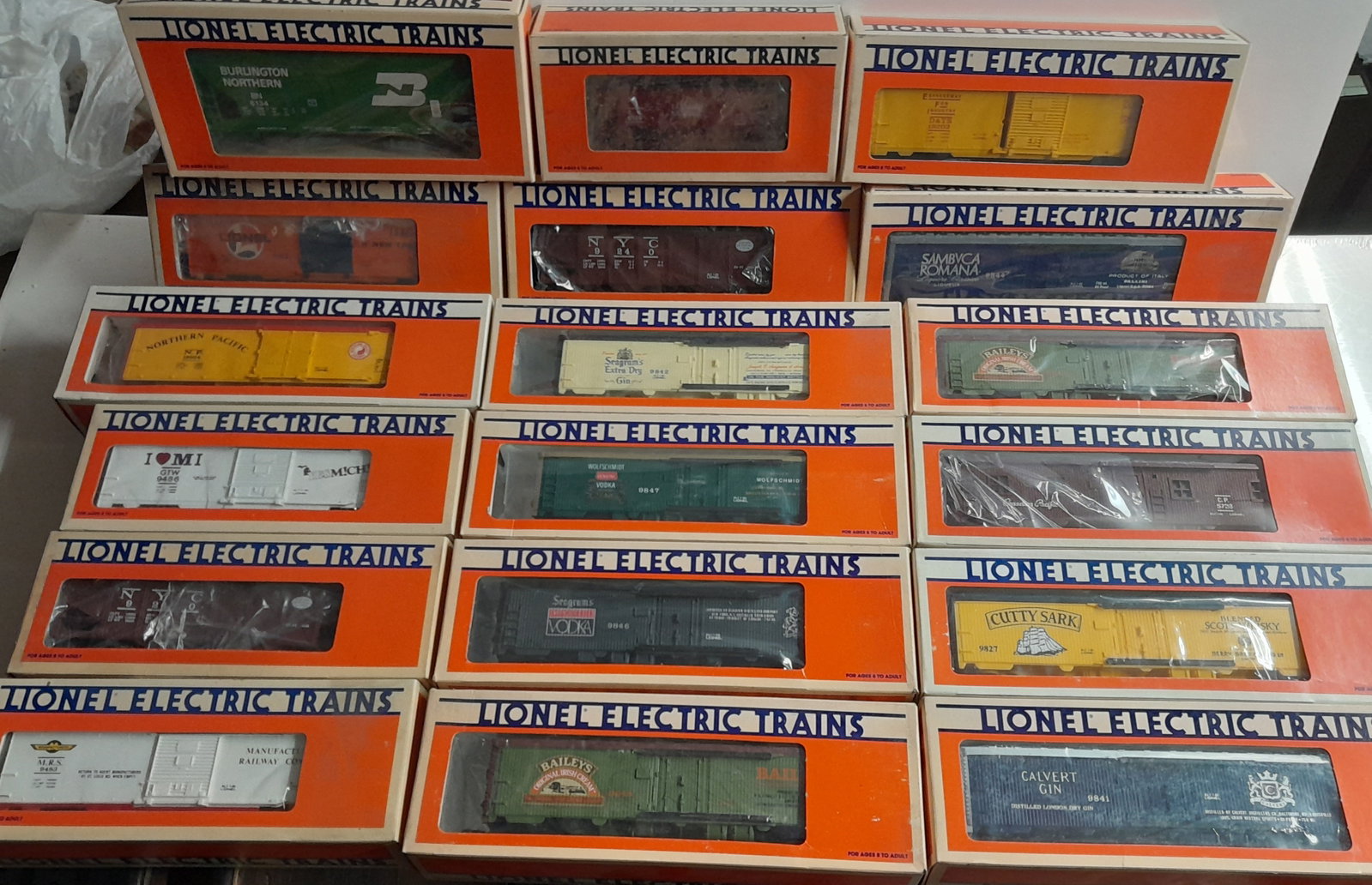 Lionel O Gauge Boxed Freight Cars (18): Lionel boxed freight cars. Various age and types. Some show signs of wear to plastic windows from storage.