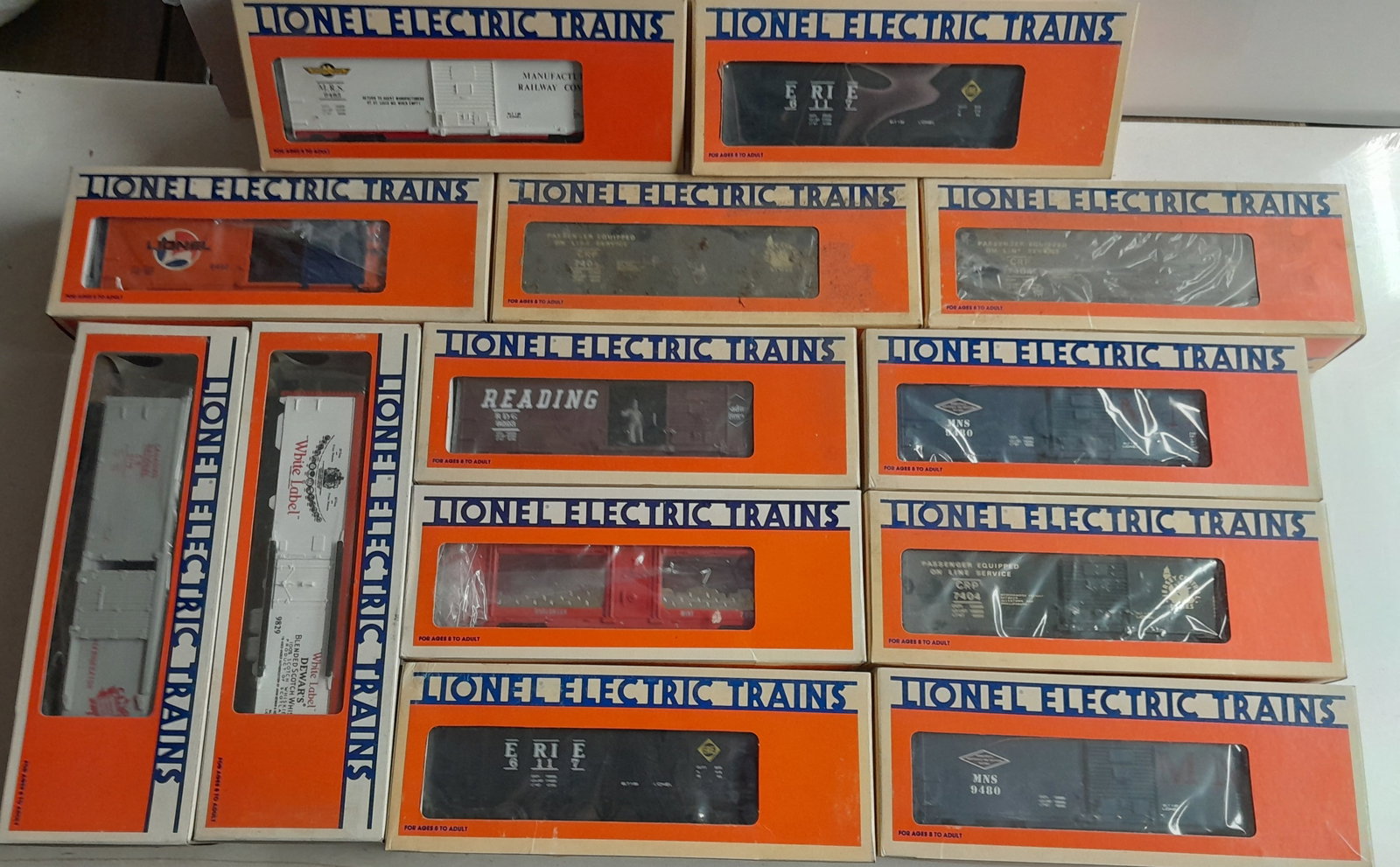 Lionel O Gauge Boxed Freight Cars (13): Lionel boxed freight cars. Various age and types. Some show signs of wear to plastic windows from storage.