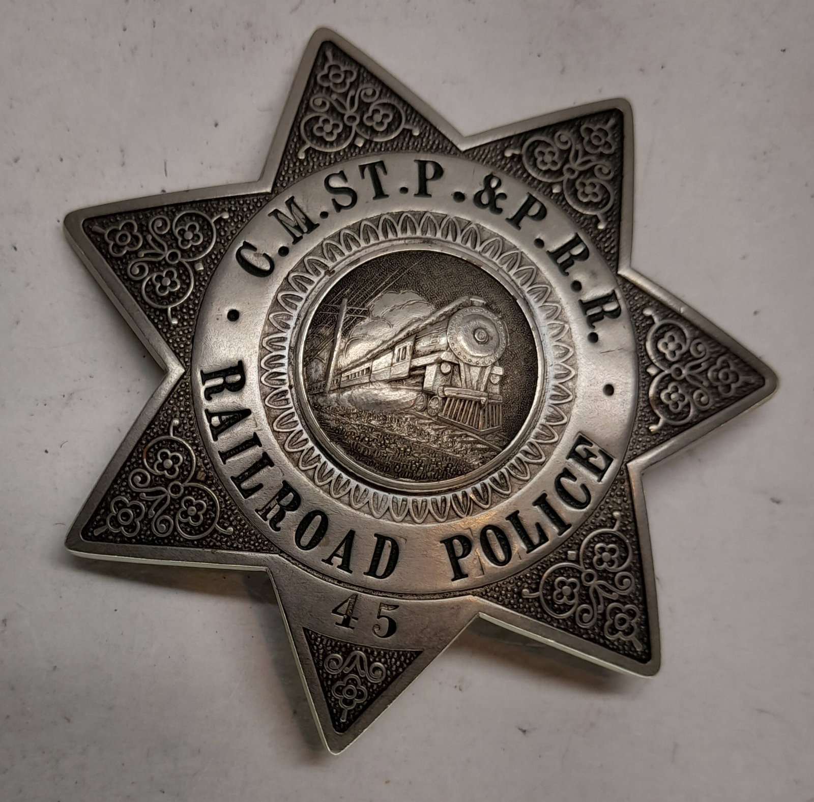C.M St. P & P Railroad Police Badge #45: A Police badge made for the Chicago Minneapolis St Paul & Pacific Railroad, it is number 45 and it has a C. H. Hanson, Chicago hallmark on the reverse. It measures about 3" across.