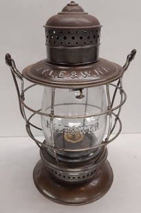 NYLE&WRR Brasstop Bellbottom Lantern Clear Cast Globe: A Steam Gauge Lamp & Lantern frame (not marked but guaranteed to be) with large block lettering on the lid of NYLE&W RR for the New York Lake Erie & Western Railroad. The brass top has an odd small nu