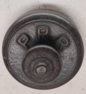 Pennsylvania Railroad Cast Iron Paperweight: A small Pennsylvania Railroad cast iron paperweight. It has PRR initials on one side in raised lettering.