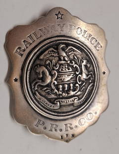 Pennsylvania Railroad Police Sterling Breast Badge: An unusual Pennsy police badge with a "star" at 12:00 and 1 2 3 at 6:00. It has Sterling and Kuhn stamped in the reverse. It measures about 2 3/8" by 3".