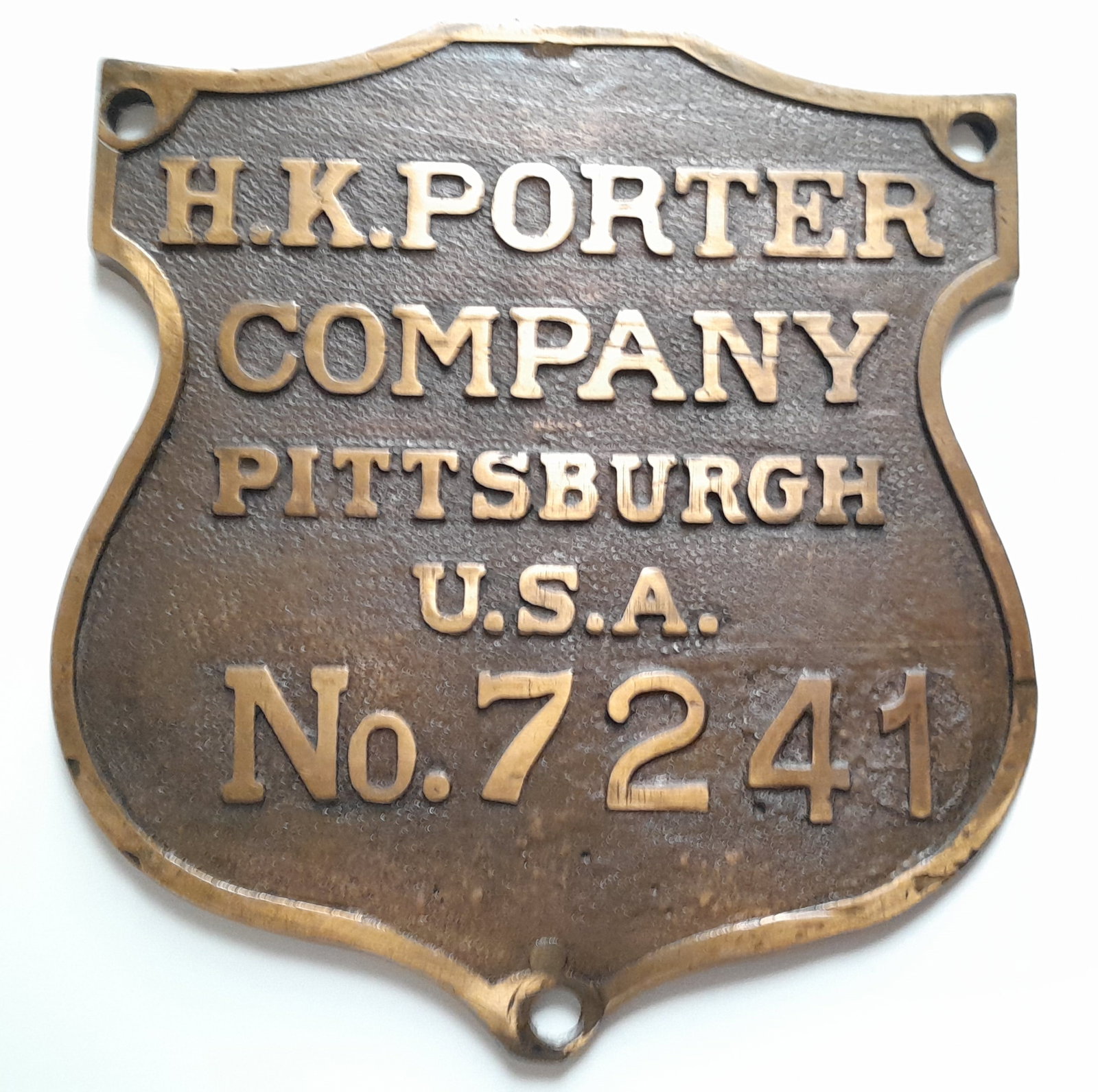 H. K. Porter Builder's Plate #7241 - Remington Arms: H. K. Porter built this gas/electric locomotive for Remington Arms in 1937. This is serial number 7241 from March of 1937. The photo shows a similar locomotive. It has some dings and the back shows re