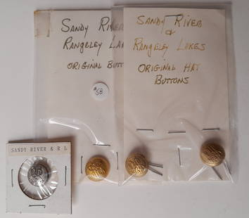 Sandy River & Rangeley Lakes Railroad Buttons (4): Smaller "cuff size" buttons, one nickel plated one brass. These are button "covers" common among Boston & Maine and Maine Central that slip over an existing button (cheap Yankees). The other 2 are sid