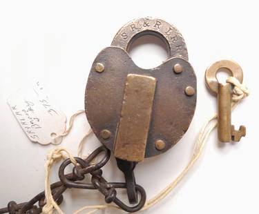 Sandy River & Rangeley Lakes Railroad Lock, unmarked Key: A Slaymaker lock made for the Sandy River & Rangeley Lakes Railroad in Maine. This was a 2 foot gauge line. The lock has a Slaymaker hallmark on the shackle and the key is unmarked but it is a Slaymak