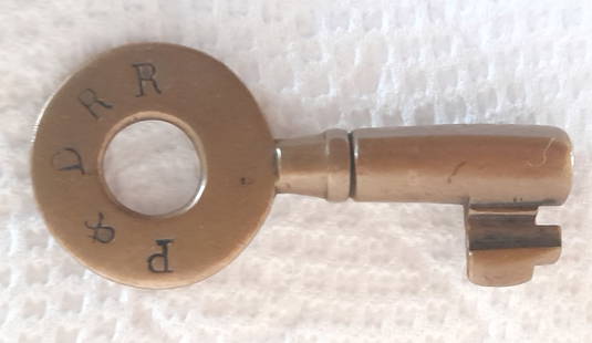 Portsmouth & Dover Railroad "C"ar Key Tapered Barrel: An early car key from the Portsmouth & Dover Railroad. It has a "C" at 6;00 on the reverse.. This name pre-dates the progress up to Rochester, New Hampshire. No maker, nice wear.