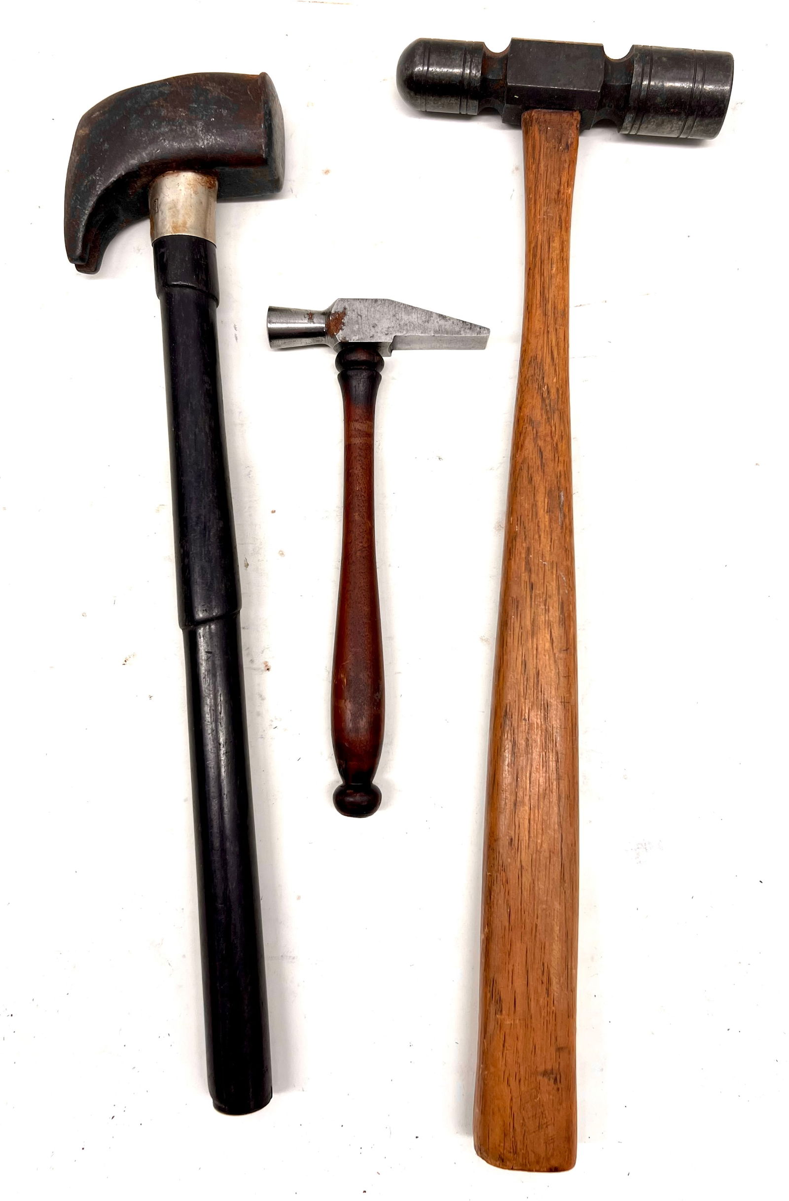 Three better hammers;: Three better than typical hammers; a finely made machinist's, a smaller with a turned (mahogany?) handle, and an turned ebony handle with oddly shaped claw head.