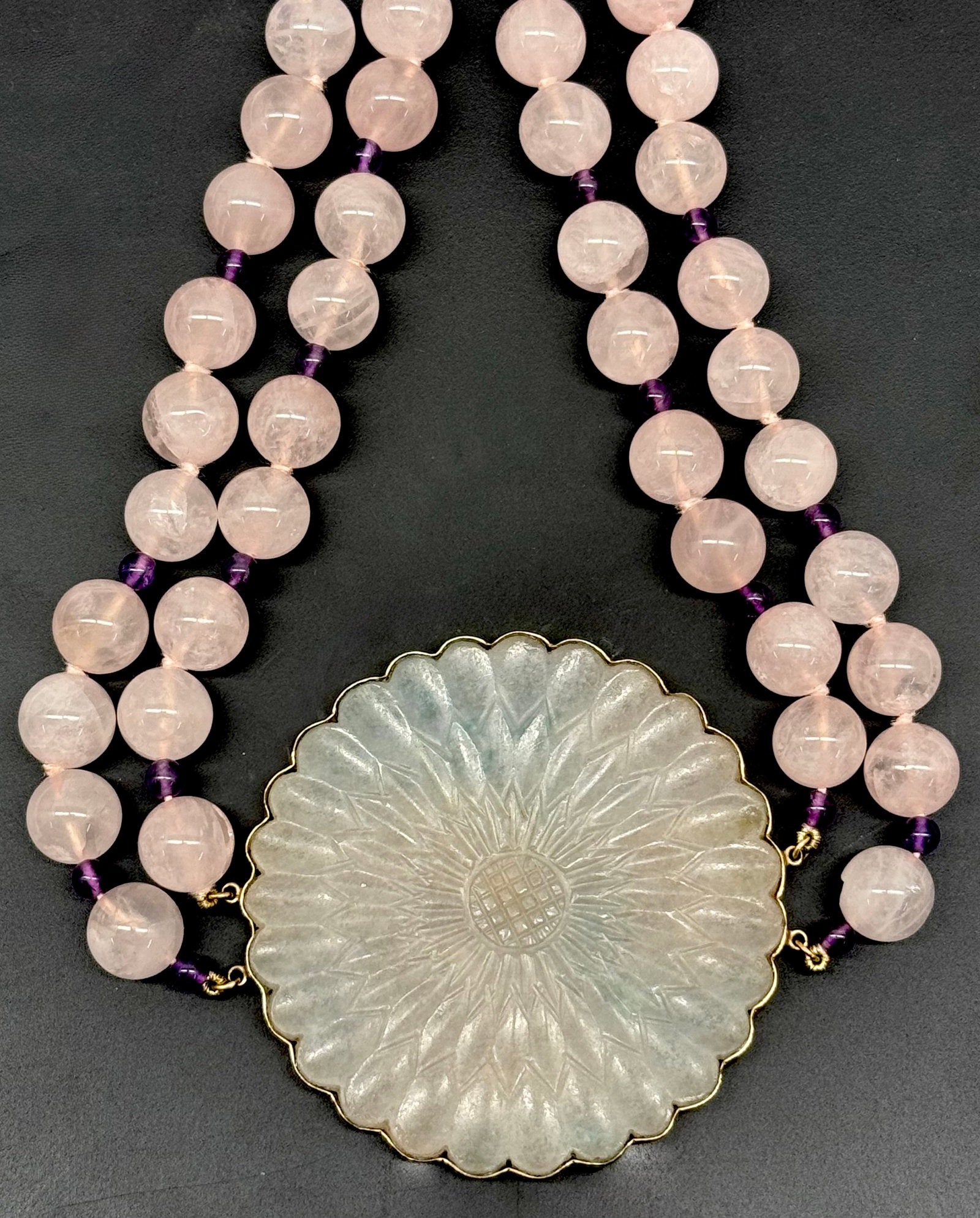 Carved Sunflower Pendant Necklace: Carved Sunflower Soapstone Pendant Encased in 14K Gold Surround. Connected by a Double Row of Rose Colored Beads Approximately 16" Long. The Pendant Measures 2.5"