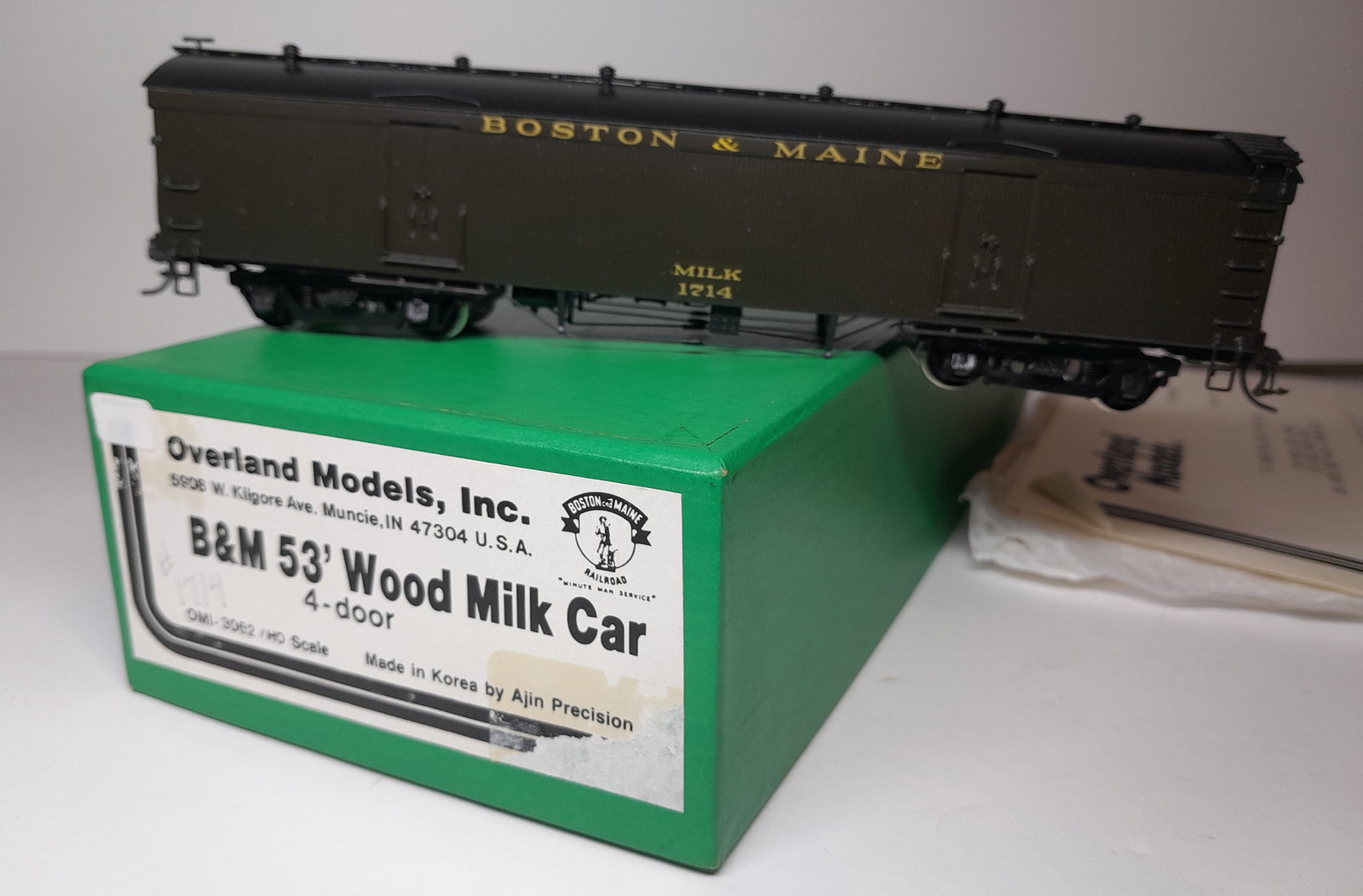 HO Brass - Overland Milk Car 53' B&M c/p #1714: HO scale brass - Overland 3062 a 53' wooden milk car with very nice custom paint as #1714. Made by Ajin in Korea. Box and foam are fine, OMI bits bag included. OMI paperwork is included. Excellent con