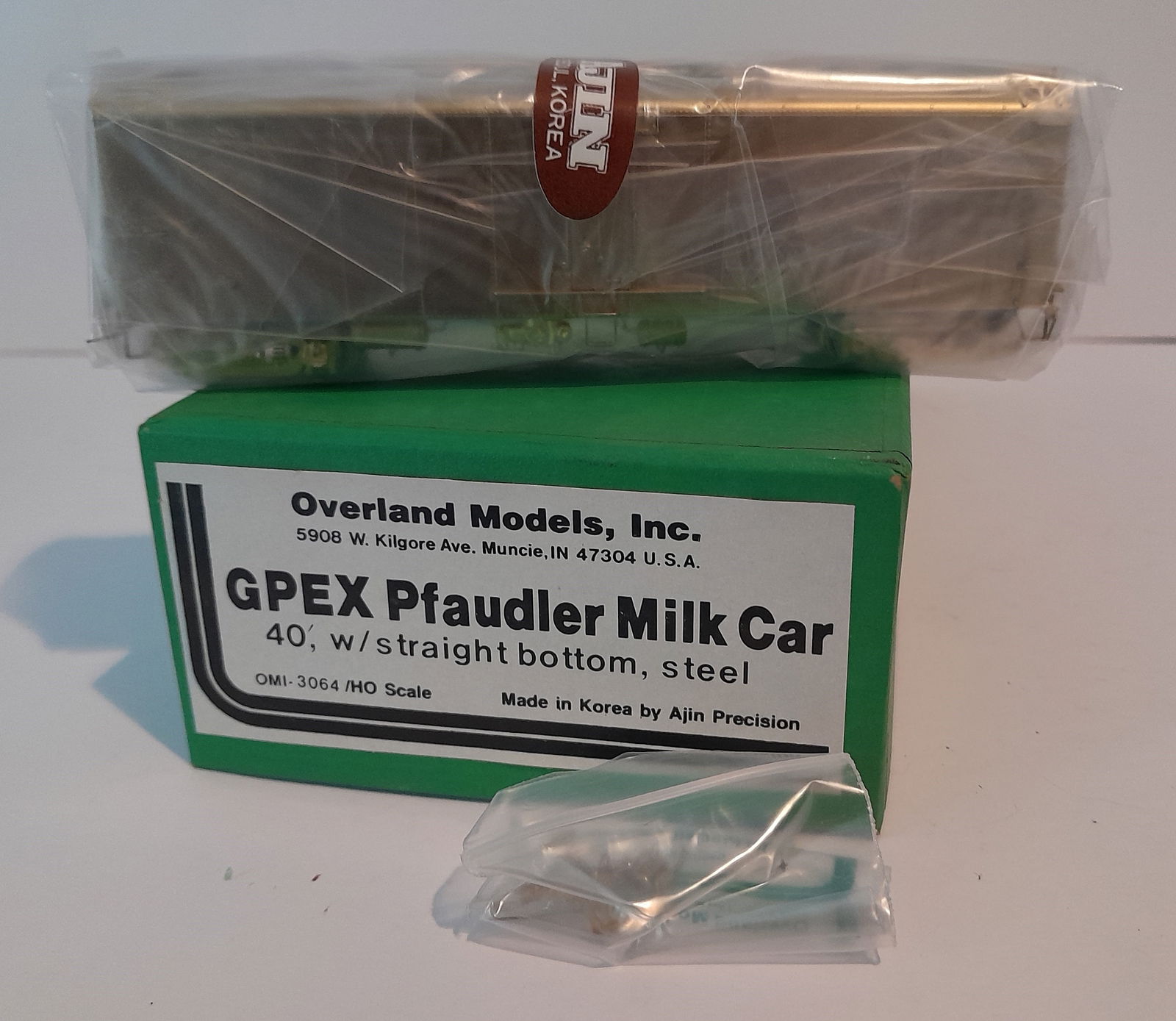 HO Brass - Overland Milk Car OMI-3054: HO scale brass - Overland imported milk car. Made by Ajin in Korea. Still in original factory wrap. Box and foam are fine, OMI bits bag included. OMI paperwork is included. GPEX #3054 40 1/2'. Excelle