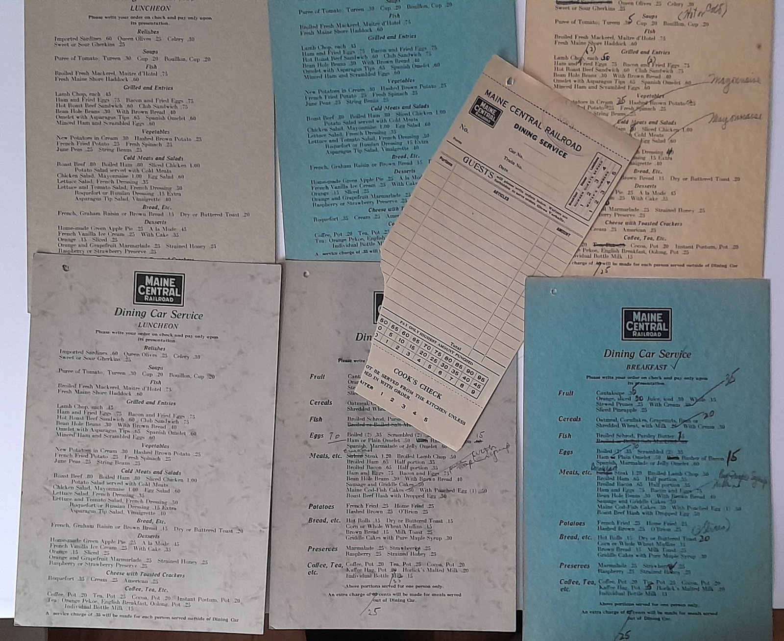 Maine Central Menus (6) & Order Slip: Maine Central Railroad dining car menus (6) 2 Breakfast and 4 Luncheon. Several with higher prices penciled in. All are 2 sided cardstock with drinks on the reverse. Like other Maine Central menus the