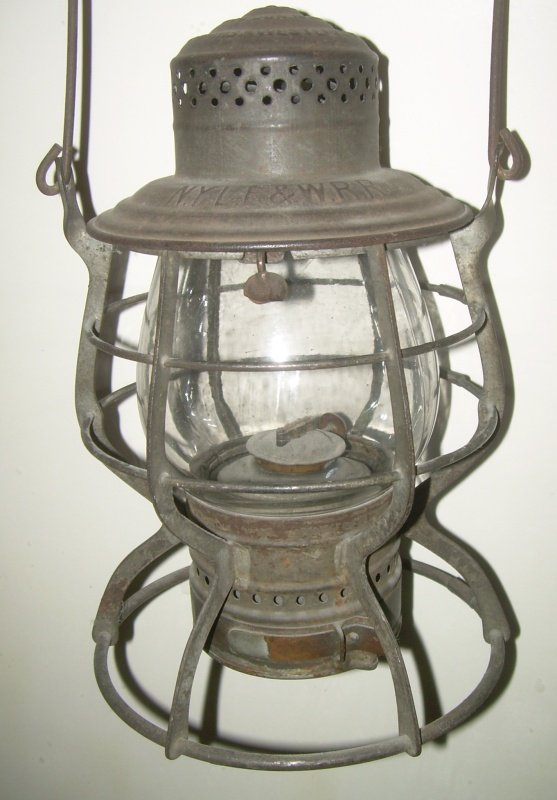New York Lake Erie & Western A&W Lantern: A nice all original Adams & Westlake "Adams" model lantern frame. No dings, dents or other damage. The frame stands very straight. The lid is clearly stamped "NYLE&W RR". This was the name used by the