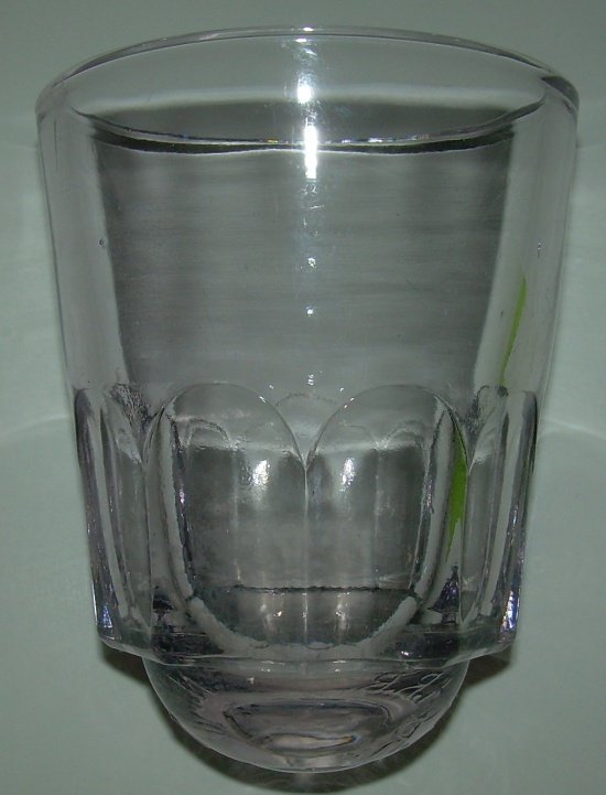 New Haven RR Round Bottom Drinking Glass: A round bottom NYNH&HRR Water Glass. These were banned by WWI because of disease. It stands 4" tall. The green strip on one side is the reflection of a pending inventory sticker. The glass is wonderfu