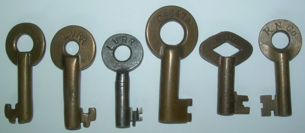 6 Brass Switch Keys: LVRR, PRR, RGD: 6 mixed Switch keys. Start with 3 Lehigh Valleys. The first two are showing wear. #3 is an odd tapered barrel steel version with a very unusual bit. #4 is a big PRR or Penn Central with a "C6647A" mar
