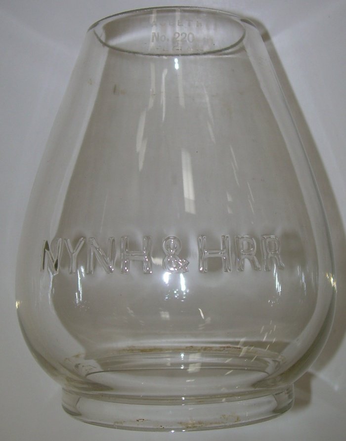 New Haven Railroad Lantern Globe EB 5 1/2": Small lettering on this extended base NYNH&HRR cast lantern globe. It has the MacBeth 220 hallmark etched at the very top. A nice example that fits several earlier New Haven lantern frames. Note that 