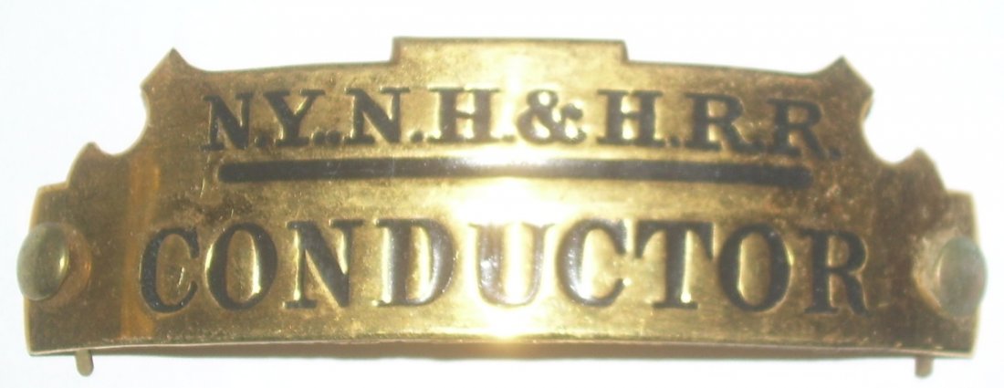 New Haven Conductor Hat Badge: NYNH&HRR "notch top" style New Haven hat badge. Included are the mounting buttons. No maker's hallmark on the back.4" long