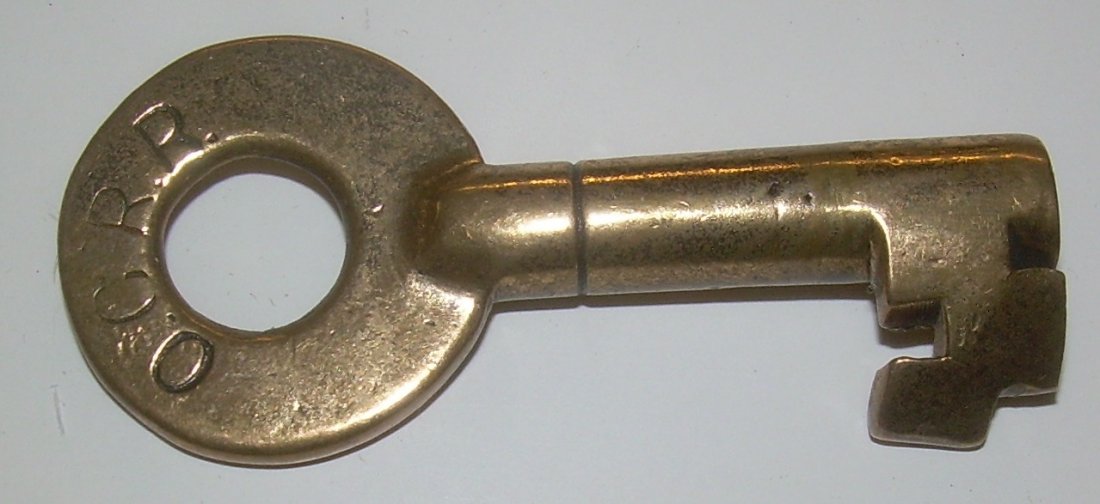Old Colony Railroad Brass Switch Key: Old Colony Railroad brass switch key made by Bohannan with a single ring on the barrel and “290 S” on the reverse side with the Bohannan hallmark. The Old Colony Railroad was absorbed by the New H
